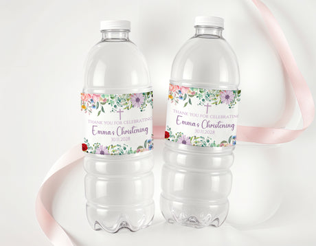 Personalised christening water bottle labels on two clear drink bottles with floral cross design