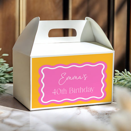 Yellow gable favour box with pink 'Emma's 40th Birthday' label and handle cut-out
