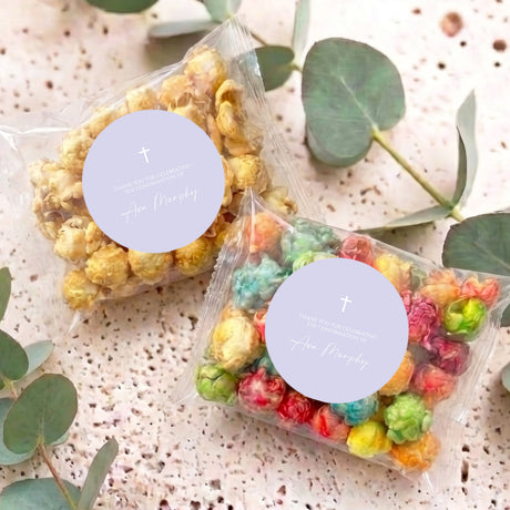 Personalised popcorn bag set with two clear bags of colorful popcorn and round lavender labels