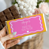 Bridal shower chocolate bar with pink wrapper and wavy border, 'Angel's' text