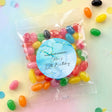 Personalised jelly bean bag with blue round label and multicolored candies in clear pouch