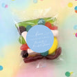 Personalised lolly bag with mixed sweets and round blue thank-you label