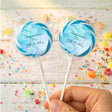 Kids birthday personalised lollipops, blue marble labels on clear crinkled wrappers, on sticks