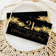 Black chocolate bar wrapper with gold stars and “21” birthday message