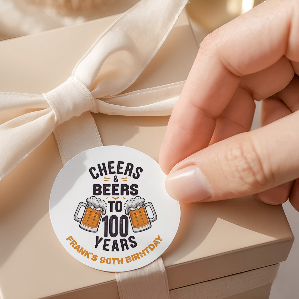 Round printed birthday label: Cheers & Beers to 100 years, with beer mug icons