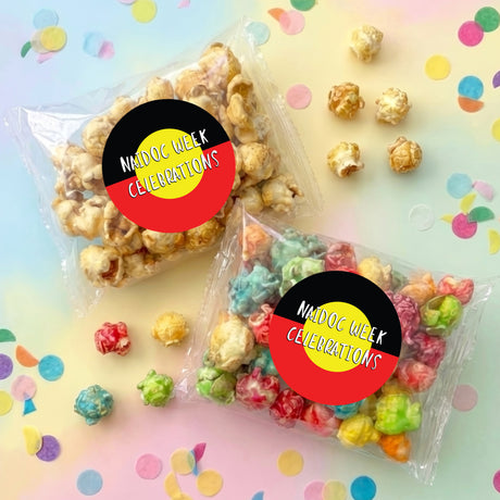 Personalised popcorn bag set with NAIDOC Week Celebrations stickers, filled with popcorn.