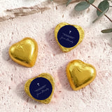 Foil heart chocolates with dark blue label and cross; gold foil hearts