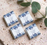 Set of personalised mini chocolates with blue floral wrappers arranged on textured surface