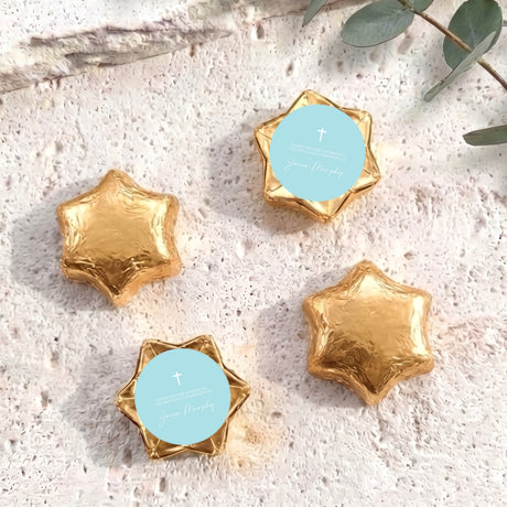 Gold foil-covered chocolate stars with cross medallion labels
