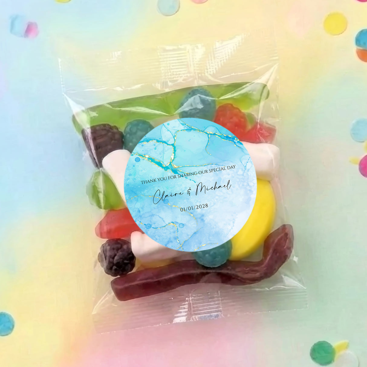 Personalised lolly bag with round blue label and mixed candy lollipops in clear pouch