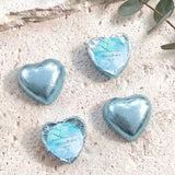 Foil-covered chocolate hearts in light blue with personalized blue label on top