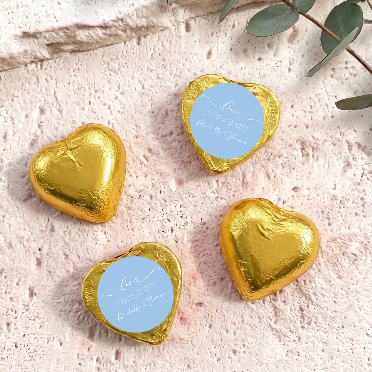 Gold foil heart chocolate favors with round blue personalised label