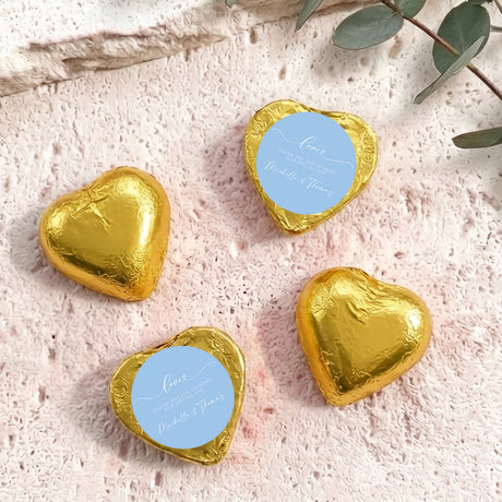 Gold foil heart chocolate favors with round blue personalised label
