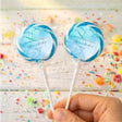 Pair of blue marbled wedding lollipops on sticks with clear candy wrappers
