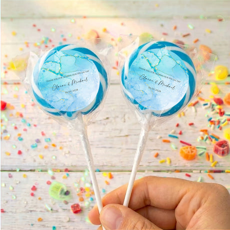 Personalised blue marble lollipops with printed names on clear-wrapped sticks