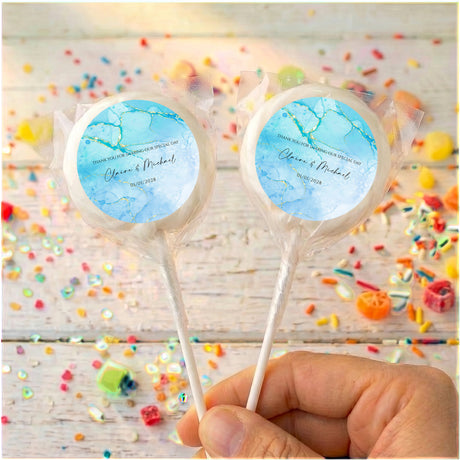 Personalised blue marble lollipops with thank-you message on clear sticks
