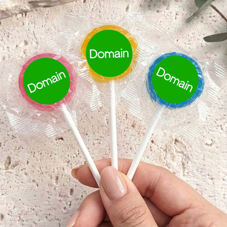 Mini lollipops on sticks with round wrappers reading Domain in green