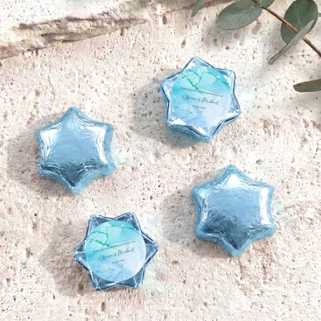 Blue foil-wrapped chocolate stars, six-point shapes with blue name label.