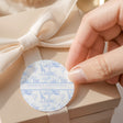 Round blue safari christening label with ribbon tie and animal pattern