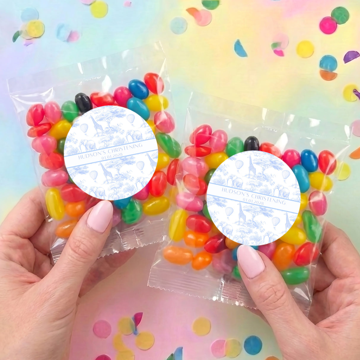 Pair of personalized jelly bean favor bags with round labels and colorful candy beans