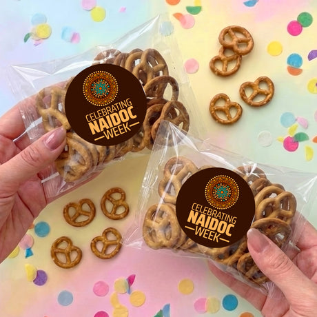 Personalised pretzel bag with pretzels and round NAIDOC Week sticker