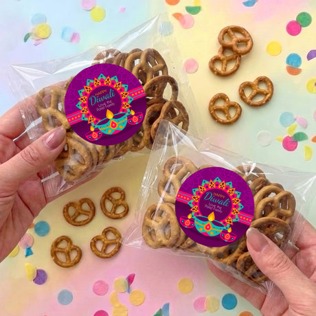 Personalized Diwali pretzel bag set with purple round label and clear plastic sleeves