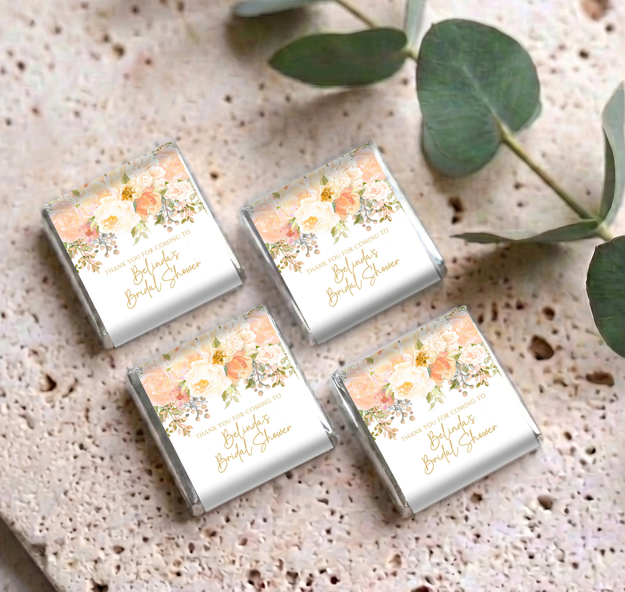 Four mini chocolates in silver foil with peach rose floral wrappers and thank-you text