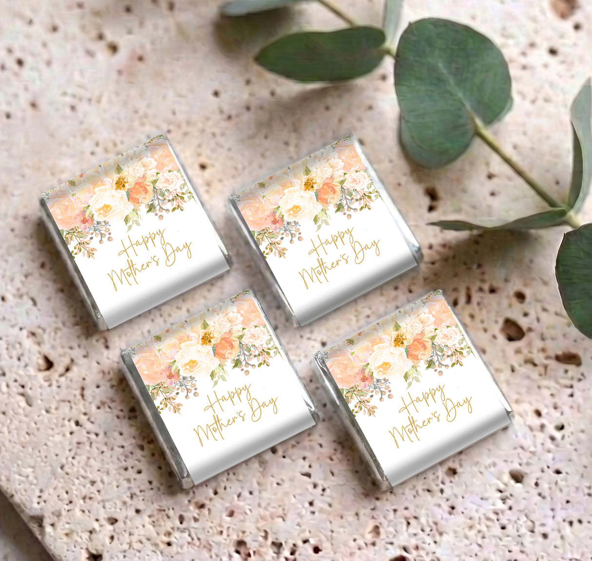 Set of four mini chocolate boxes with floral 'Happy Mother's Day' labels on surface