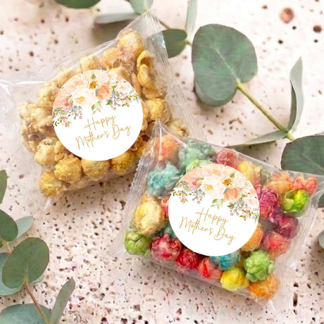 Two personalised popcorn bags with floral round tags reading 'Happy Mother's Day'