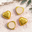 Gold foil-covered chocolate hearts with beige round labels and heart shapes