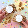 Christening personalised pretzel bag with clear wrap and round label, holding mini pretzels