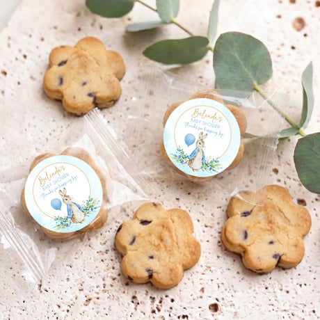 Set of choc chip cookies with round baby shower blue rabbit floral labels, wrapped
