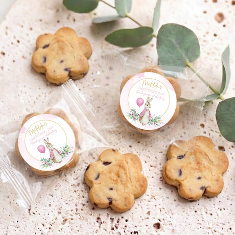 Set of chocolate chip cookies in clear wrappers, each with Matilda's christening round label