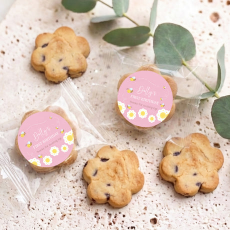 Personalised bite-size chocolate chip cookies with two pink 'Dolly’s' First Birthday stickers