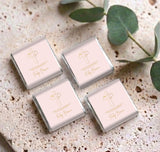 Set of four pink dove cross mini personalized chocolates with cross logo on wrappers