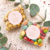 Personalised popcorn bags with cross logo and round name labels, two bags