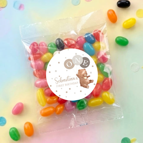 Jelly bean gift bag with clear wrap and round bear label, filled with colorful sweets