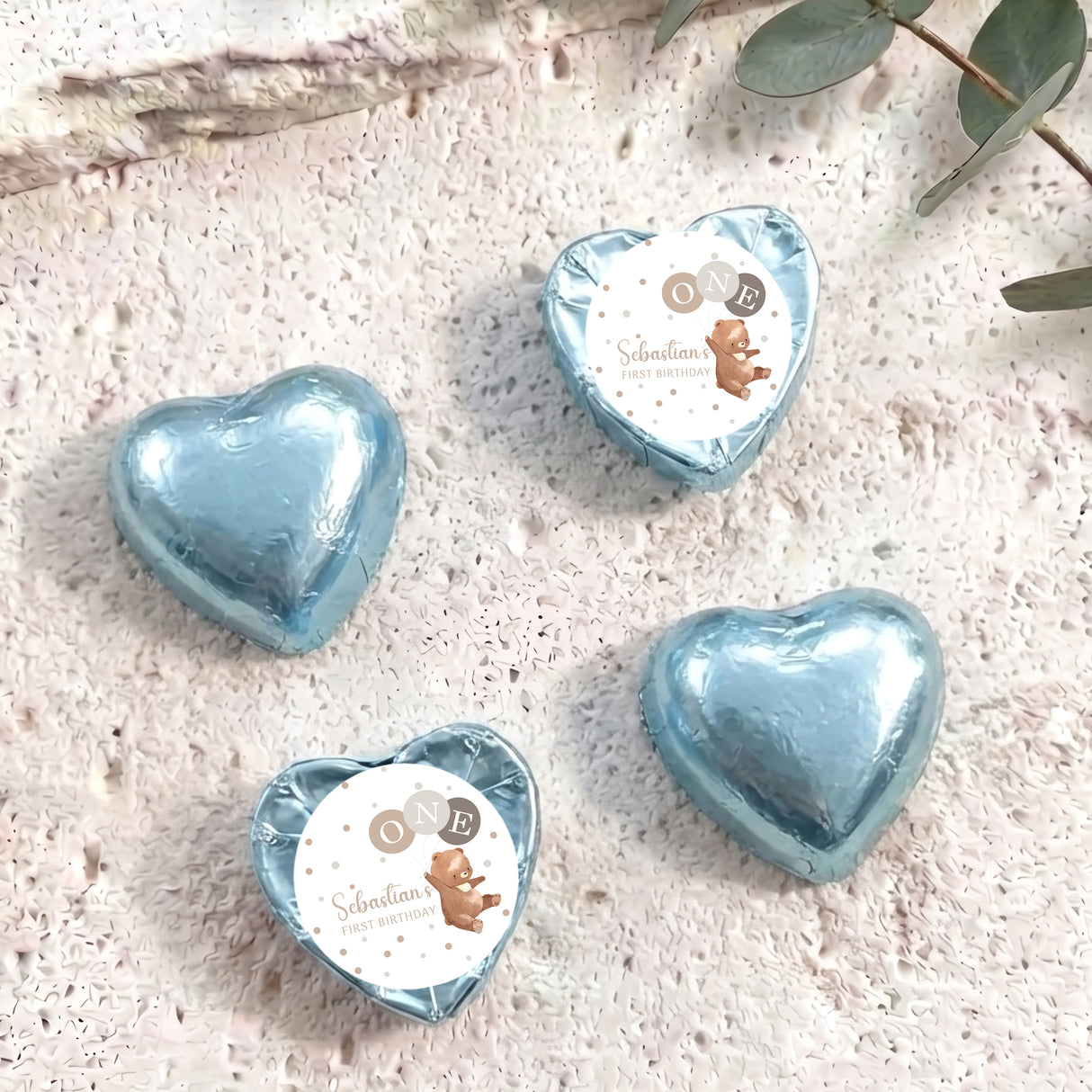 Foil-covered chocolate hearts, light blue heart balloons in a set of four