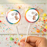 Personalised baby lollipops with rainbow-rim bear label on clear wrapped sticks