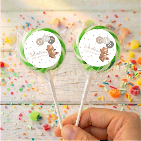 Personalised baby lollipops with green-rim bear label on clear wrapped sticks