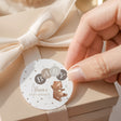 Round baby shower printed label with teddy bear illustration, dotted border, and BABY letters
