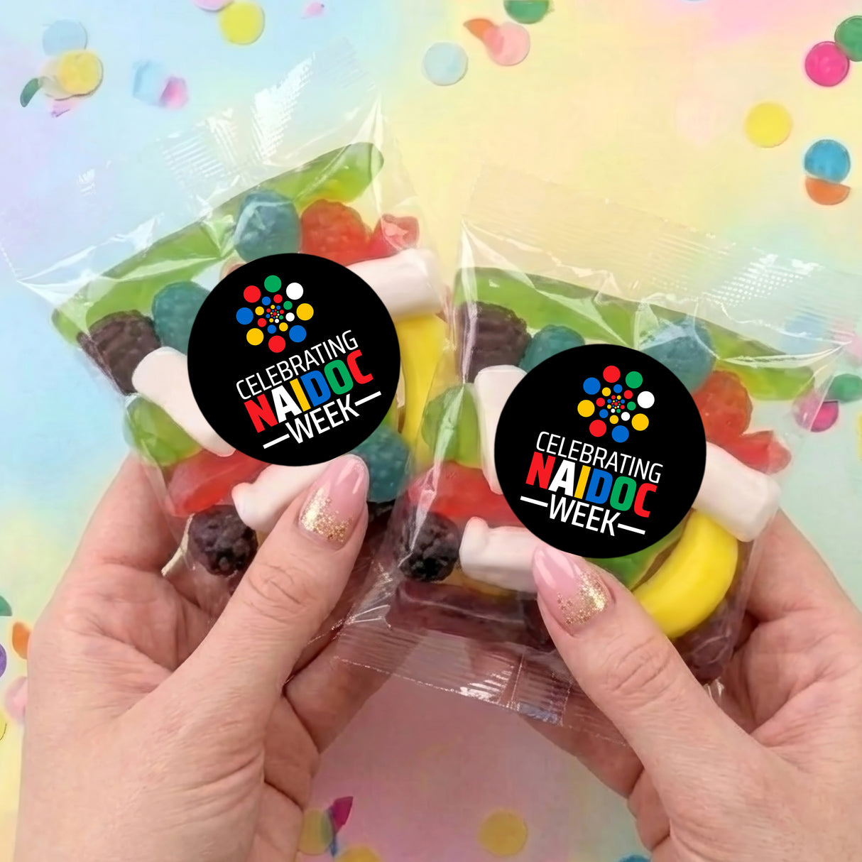 Two personalised party mix lolly bags in clear wrap with NAIDOC Week stickers