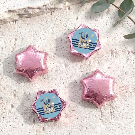 Foil-covered chocolate stars with personalized label, pink foil star shapes