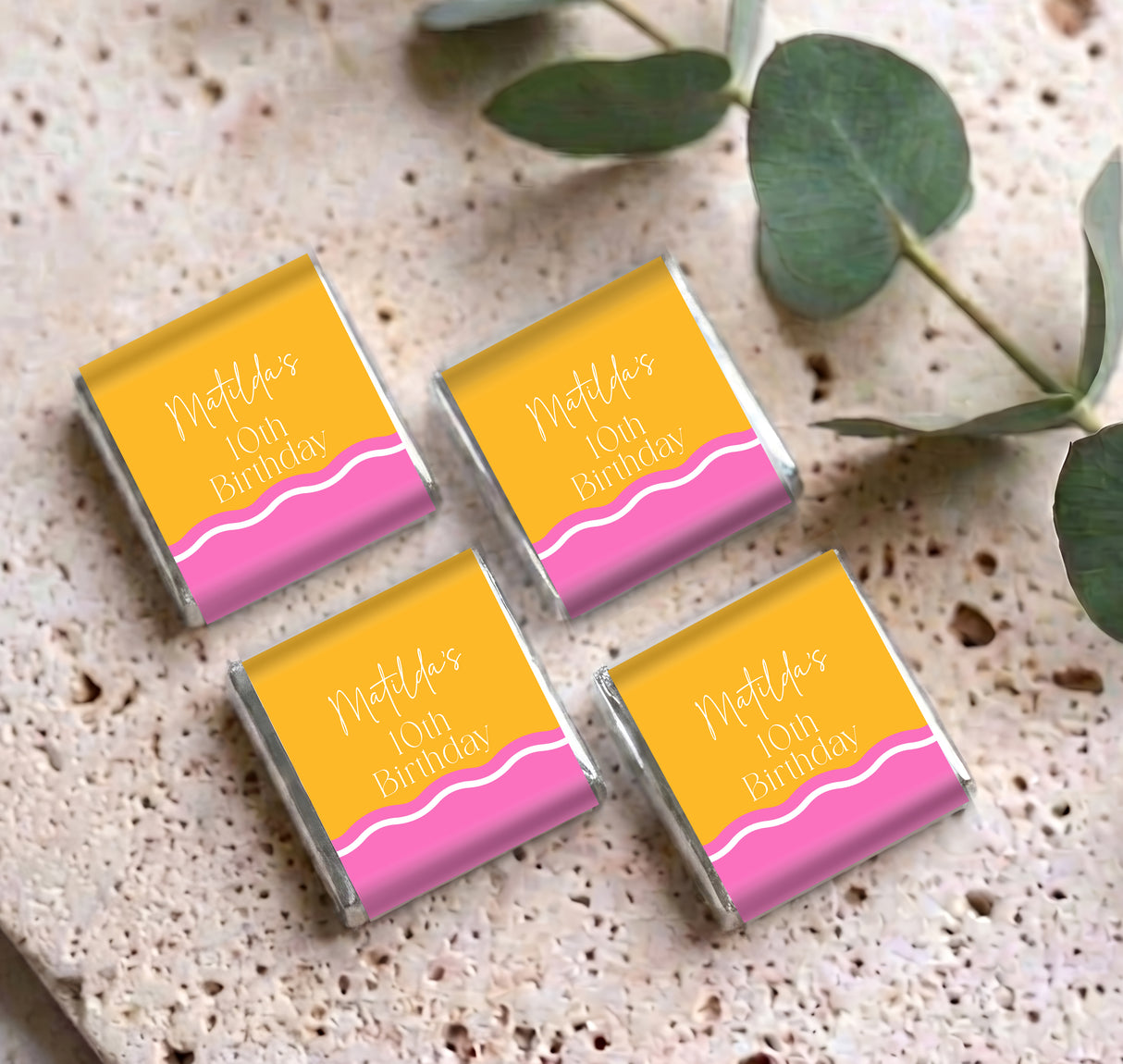Set of personalised mini chocolate favors, pink/yellow wrappers with birthday message text