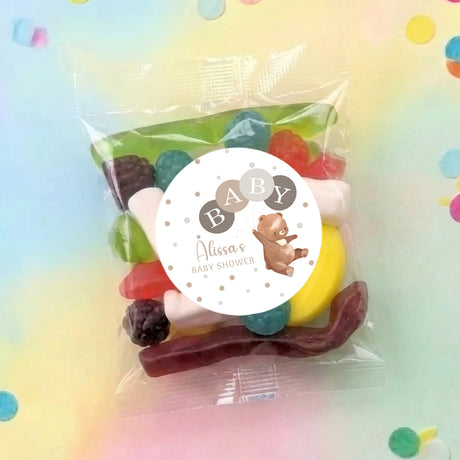 Personalised baby shower lolly bag in clear wrap with colorful sweets and round 'Baby' label