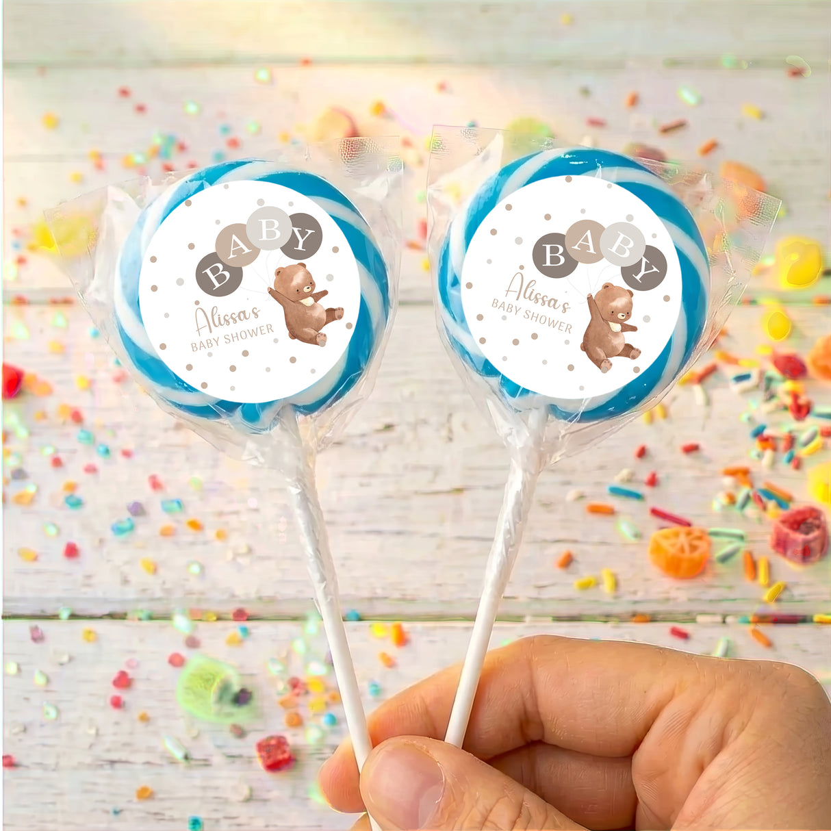 Baby shower personalised lollipops with blue round label, clear wrapper, plain sticks