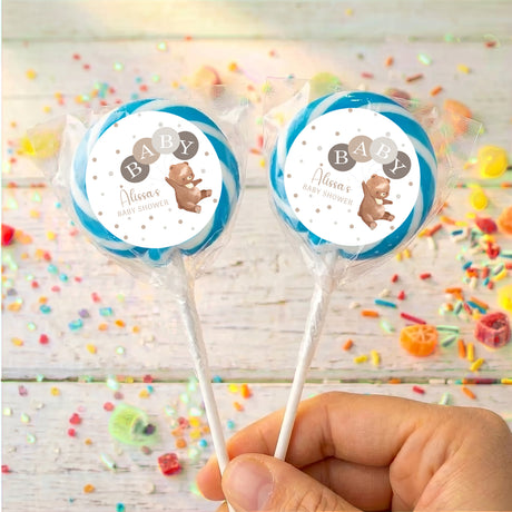 Baby shower personalised lollipops with blue round label, clear wrapper, plain sticks