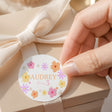 Round daisy-printed birthday label with floral border, AUDREY and 'for 3' text