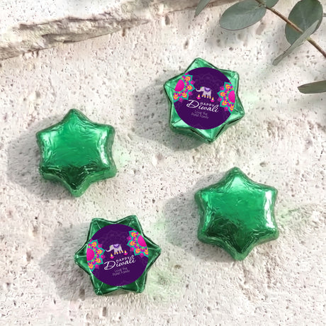 Green foil-covered chocolate stars in star shapes with Diwali elephant label.