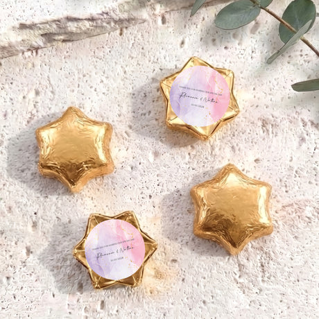 Gold foil star chocolates with circular personalized label in star-shaped wrapper